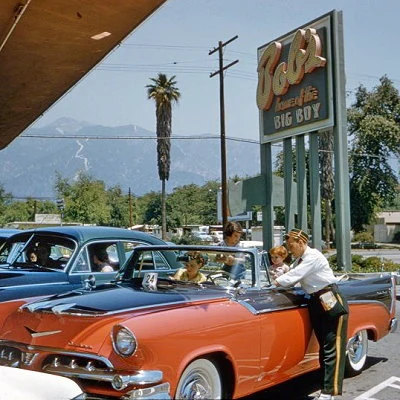 Car hop taking an order from a family at Bob's Big Boy Drive-In in suburban Los Angeles.