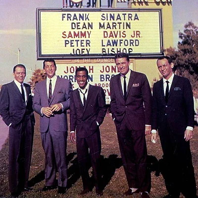 The "Rat Pack" in front of the sign announcing their appearance at the Sands Hotel in Las Vegas.