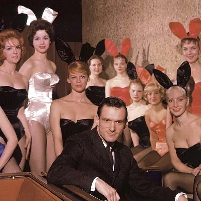 The founder of Playboy Magazine, Hugh Hefner, poses with bunnies at the opening of the first Playboy Club in Chicago.