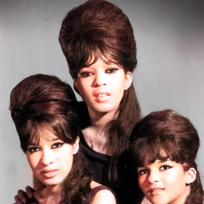 Towering hairdos known as beehives or B-52's are in fashion. American girl group The Ronettes demonstrate.