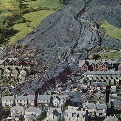 A slag heap from a local coalmine slides down the mountain into Aberfan, South Wales, UK. The landslide destroys homes and a junior school killing 144 people. Over 100 of the victims are school children aged 7 to 10.