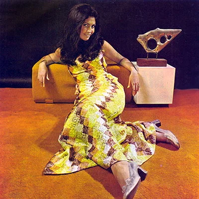 1970 advertisement showing "earth tone" carpet. Earth tone colors like harvest gold, green, orange, brown and beige are popular in 1970. Deep pile carpeting known as "shag" carpeting is also big throughout the 70's.