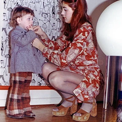 A mom helping her son get ready in 1972.