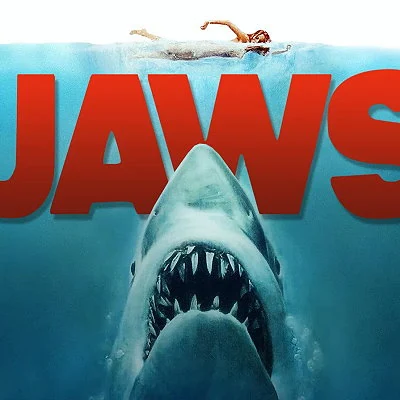 The film Jaws, directed by Steven Spielberg, becomes the highest grossing film of it's time when released in 1975. The blockbuster film, about a man-eating great white shark attacking beachgoers, spawns three sequels.