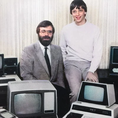 Microsoft founders and childhood friends Paul Allen and Bill Gates pose for a picture after signing a contract with IBM to develop an operating system for IBM's personal computers.