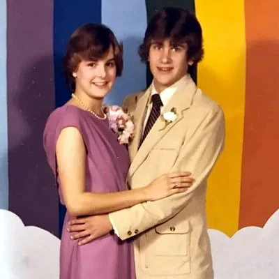 A couple pose for a photo at 1981 high school dance.