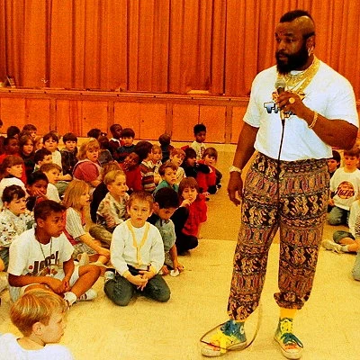 Television actor Mr. T (The A-Team) is shown sharing his "Don't be a fool...stay in school" message at an elementary school.