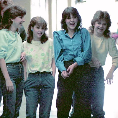 Junior high school girls enjoy a moment in the hallway.
