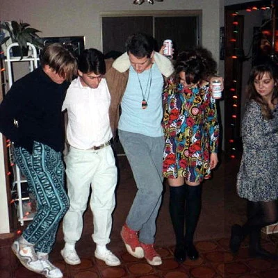 A group of high school boys trying out a new dance step.