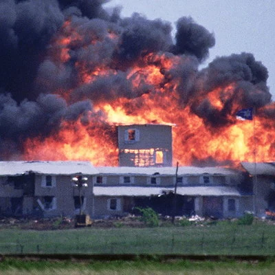 After surrounding the Waco, TX compound of the religious sect Branch Davidians, federal authorities from the ATF and FBI launch tear gas cannisters into the facility causing a large fire. The fire resulted in the death of 76 members of the sect, including 25 children.