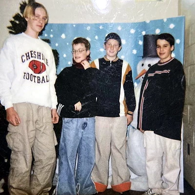 Middle school boys hanging out in the hallway.