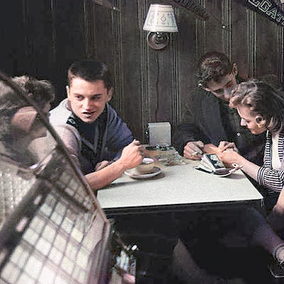 Teenagers in cafe with jukebox.